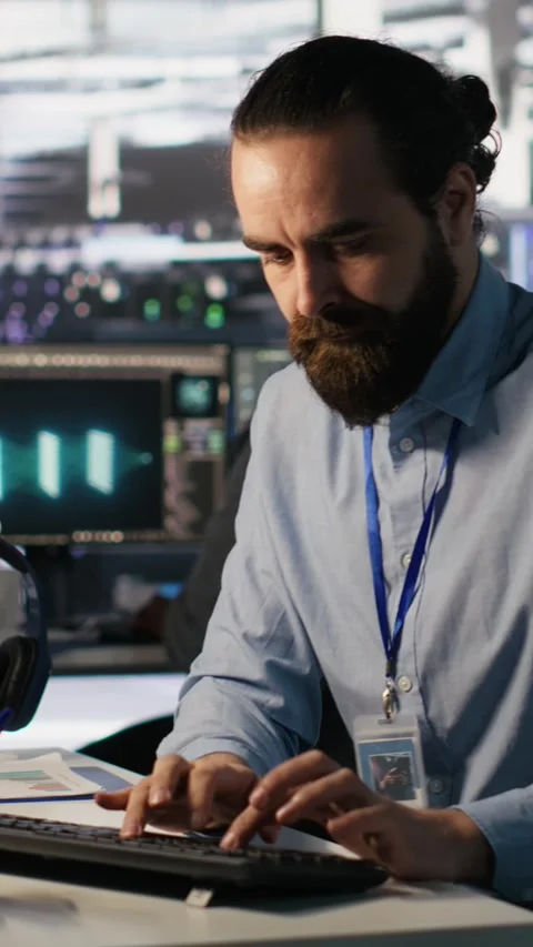 Vertical video Angry data center engineer banging fist on desk after seeing Stock Footage 309486340