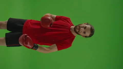 Vertical Video, Angry Professional Bearded Fighter Making Boxing Exercises Video stock 220469751