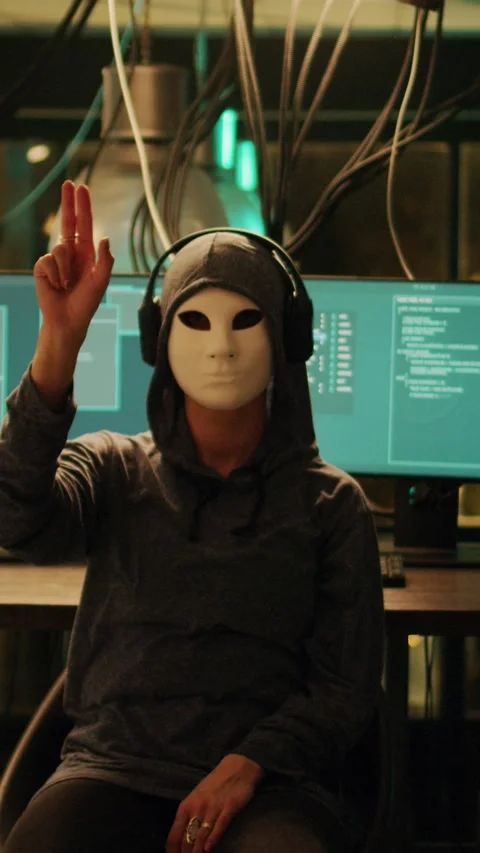 Vertical video: Anonymous hacker with mask using hologram to hack computer Stock Footage 227668201