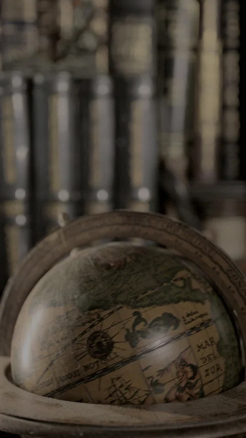 Vertical video of antique globe spinning in library Stock Footage 340032218