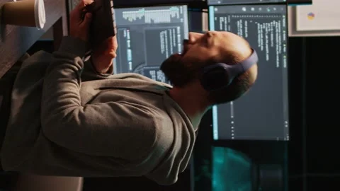 Vertical video: App developer playing air guitar in coding office Stock Footage 222211883