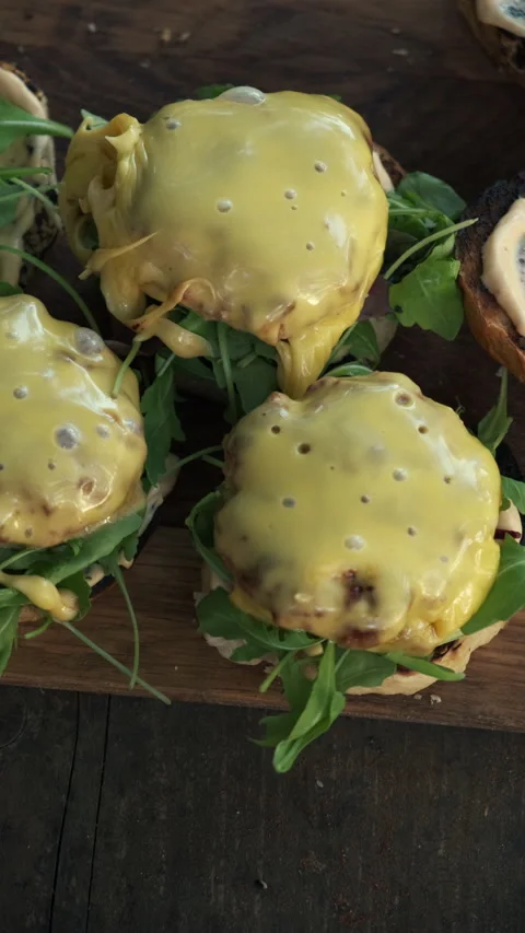 Vertical video of appetizing burger with grilled beef patty with cheese Stock Footage 286312929