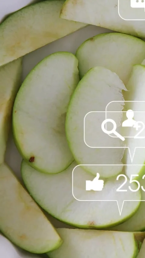 Vertical video: Apple slices sitting in bowl after 2 frames social icons Stock Footage 331738903