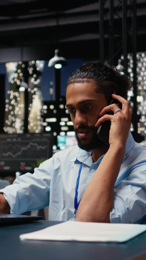 Vertical Video Arab man with disability, telephone call chat, during office work Stock Footage 334103932