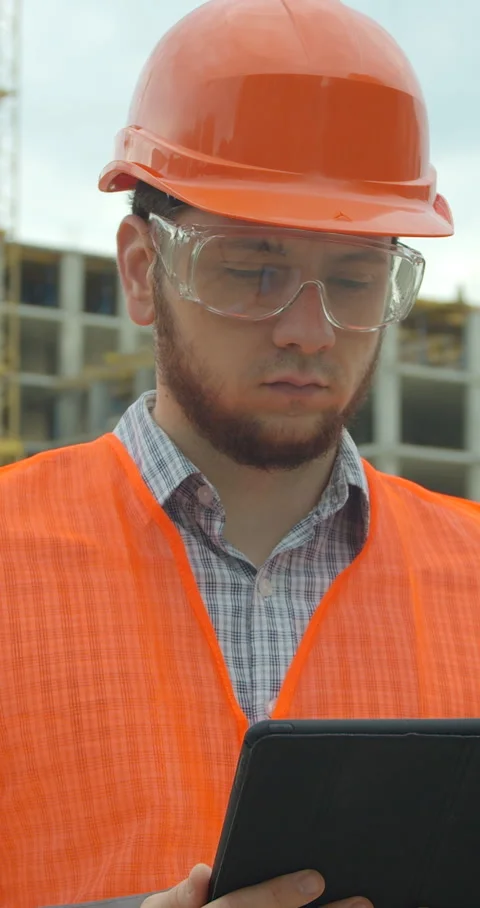 Vertical video. Architect analyzing project plan on construction Stock Footage 345503582