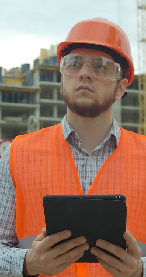 Vertical video. Architect analyzing project plan on construction site Stock Footage 345503675