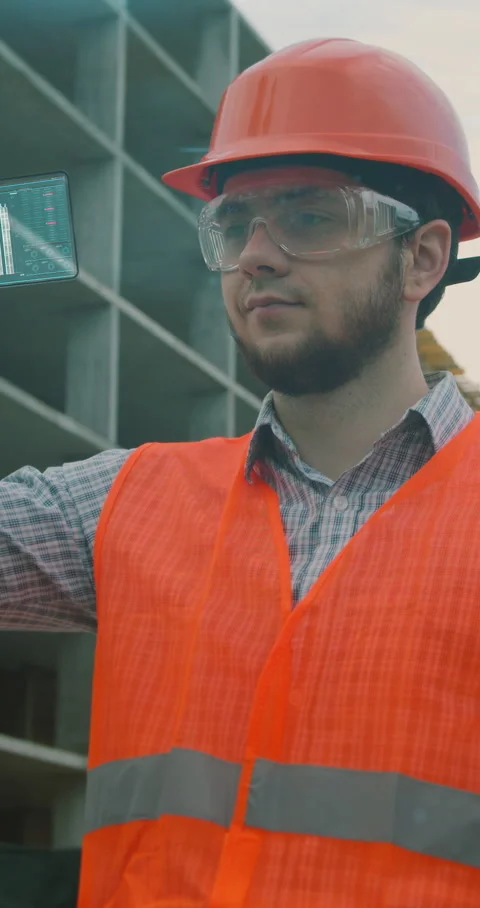 Vertical video. Architect or Engineer using smartphone transparent hologram Stock Footage 345504532