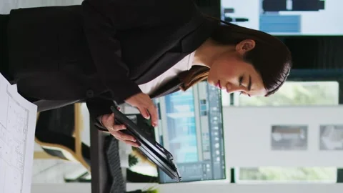 Vertical Video Architect working with project blueprint and cad software Stock Footage 263079459