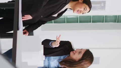 Vertical Video Architects doing high five gesture after finishing blueprints Stock Footage 263081192