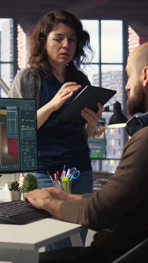 Vertical Video Architectural design team configures a floor plan on dual Stock Footage 308493068