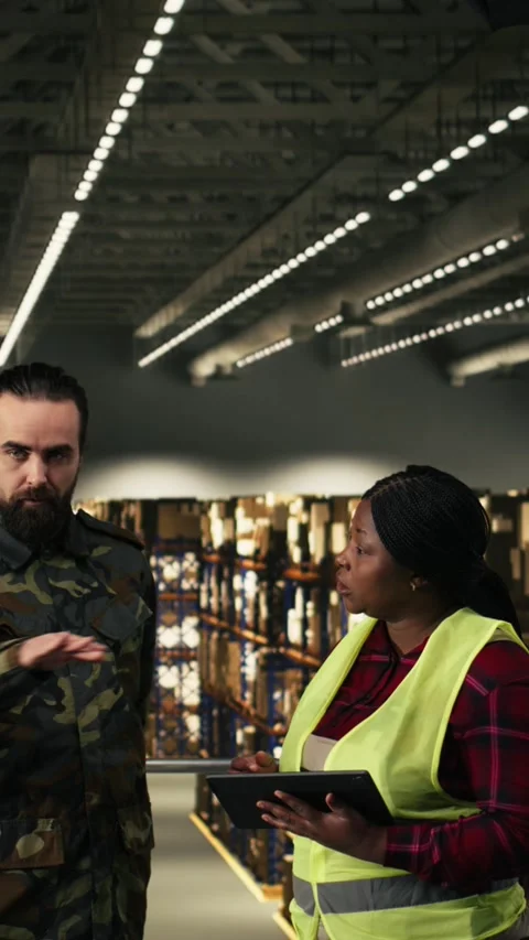 Vertical Video Army logistics team in uniform working in warehouse on military Stock Footage 330376042