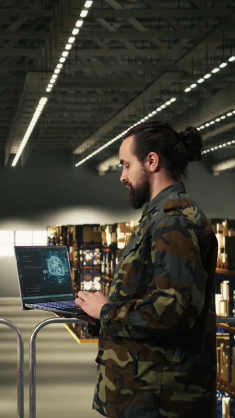 Vertical Video Army soldier using AI-powered tools in logistics hub at military Stock Footage 330439663