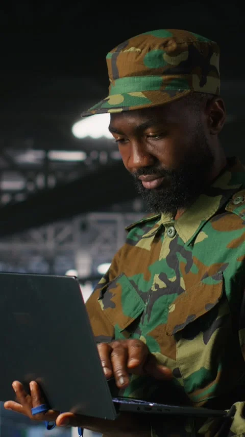 Vertical video Army technician in command center server room using laptop Stock Footage 310772968