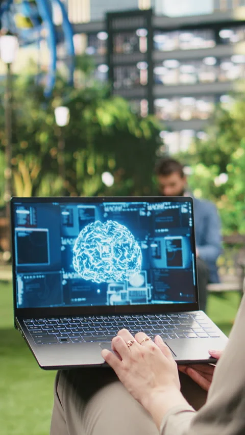 Vertical Video Artificial intelligence programming by office worker in city park Stock Footage 348650587