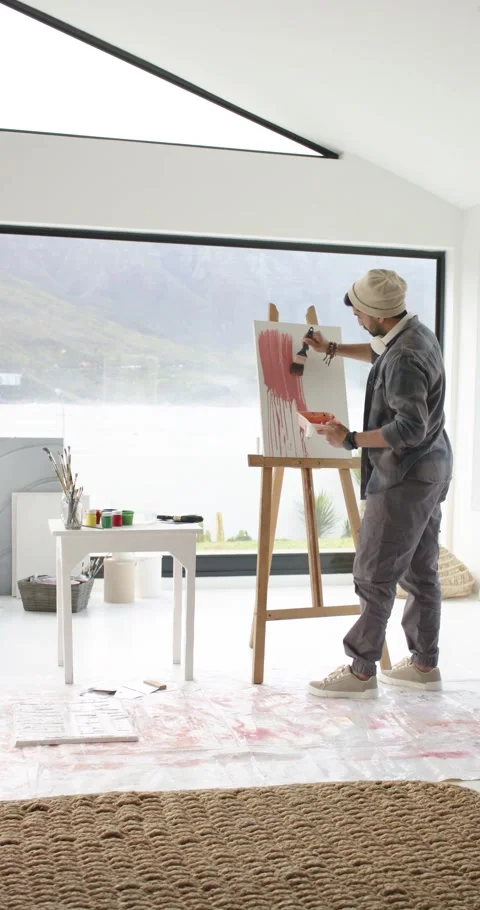 Vertical video: Artist is dipping into red paint pulling strokes on canvas in Stock Footage 345217764