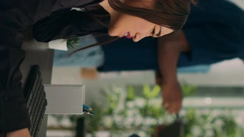 Vertical video: Asian developer coding html script information on computer at Stock Footage 219702616