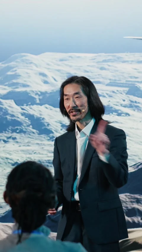 Vertical Video Asian speaker does wind energy presentation on stage featuring Stock Footage 328128366