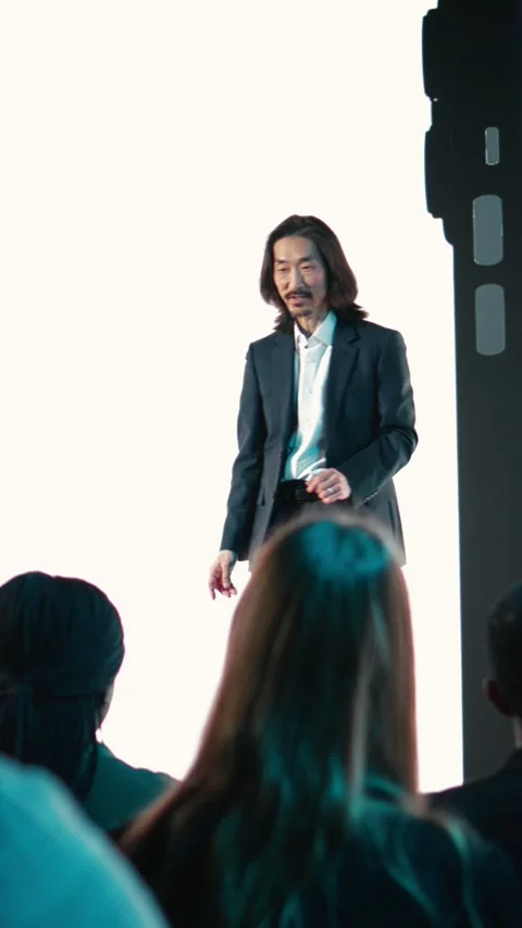 Vertical Video Asian speaker hosting new smartphone launch event showcasing Stock Footage 327624174
