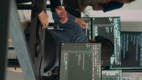 Vertical video: Asian system engineer trying to find html script and code to Stock Footage 220160276