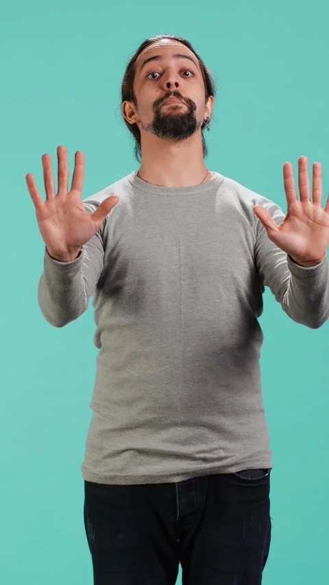 Vertical video Assertive man doing stop hand gesture sign 스톡 동영상 314516201