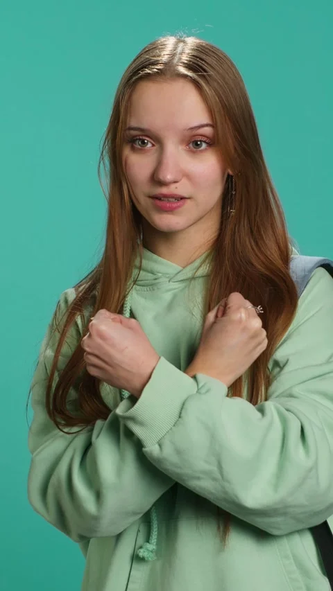 Vertical video Assertive woman shows letter X with arms crossed, staying in Stock Footage 276334705