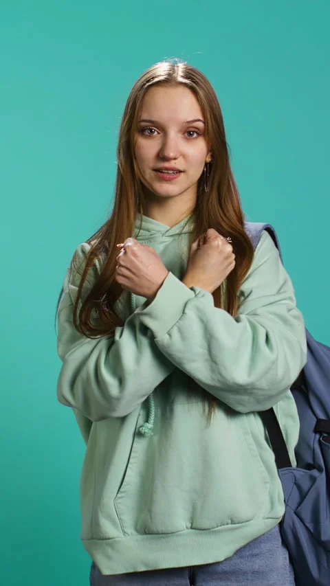 Vertical video Assertive woman shows letter X with arms crossed, staying in Stock Footage 276580334