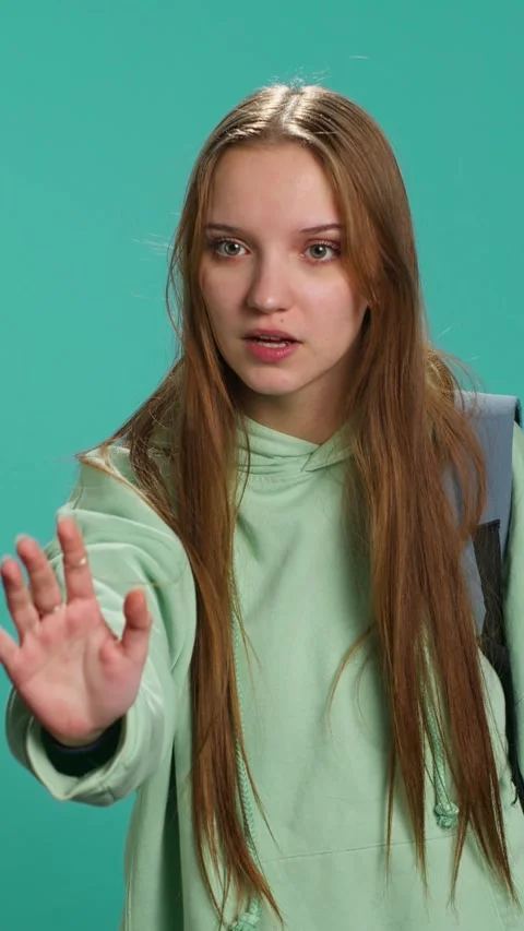 Vertical video Assertive young woman doing stop hand gesture Stock Footage 276335551