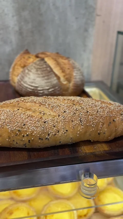Vertical video of assorted baguette and bread loaves with golden crusts Stock Footage 322967502