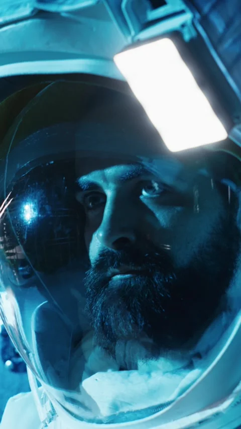 Vertical video Astronaut returning from planet surface takes helmet off, talking Stock Footage 310913896