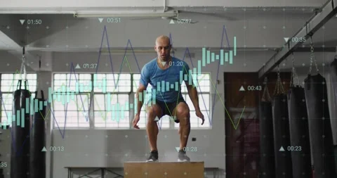 Vertical video: Athlete jumping from squat onto plyo box at gym, in blue shirt, Stock Footage 330509219