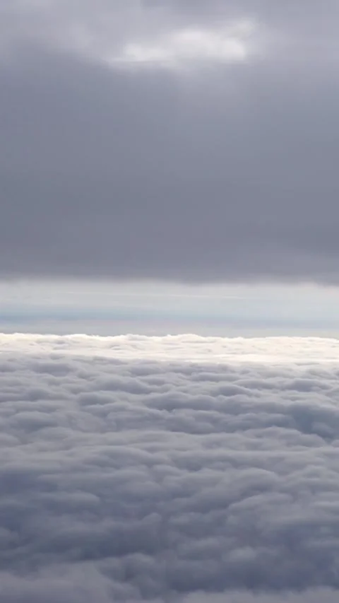Vertical video atmospheric view from an airplane window of thick white cloud Stock Footage 345211770