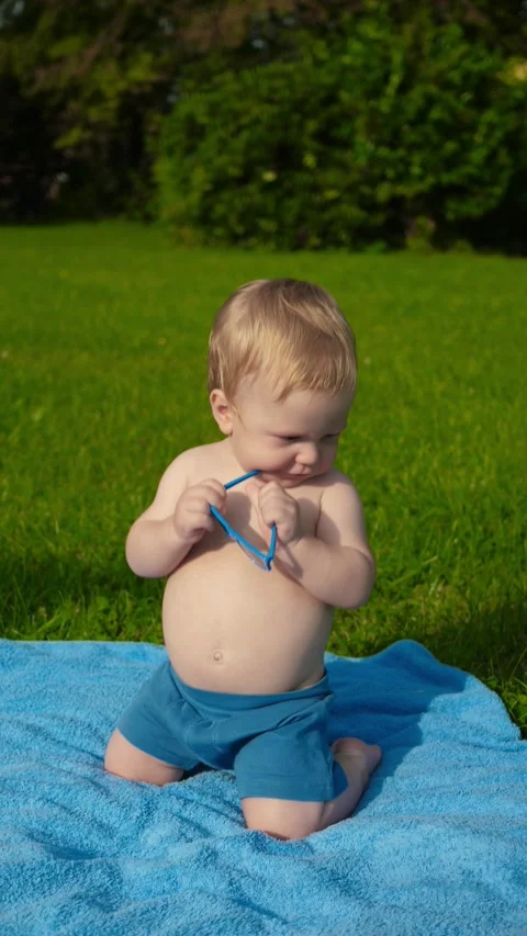 Vertical video baby on grass Stock Footage 283564420