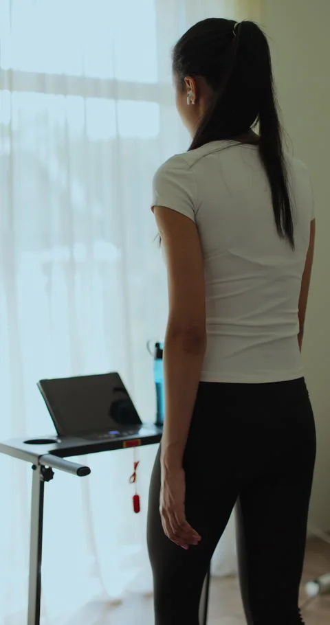 Vertical video. Back view Female is doing cardio workout training on treadmill Stock Footage 336656234