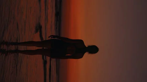 Vertical Video. Back View of the Slim Lady Thoughtful Standing Outside on the Stock Footage 260692841