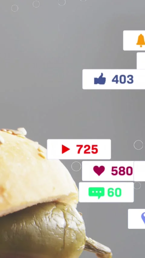 Vertical video: Badges flooding right over bun on stick pushing bun left to show Stock Footage 328398515