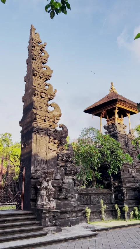 Vertical Video of Bali Temple Mirror Gate with Tower Featuring Ornate Stone Stock Footage 317080313