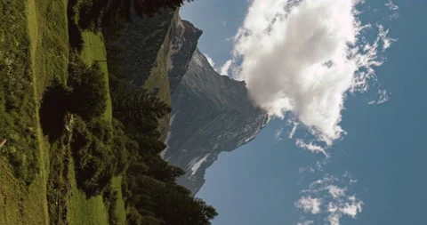 Vertical video - Banner shaped clouds on Matterhorn peak from Blatten meadows Stockbeeldmateriaal 158576880