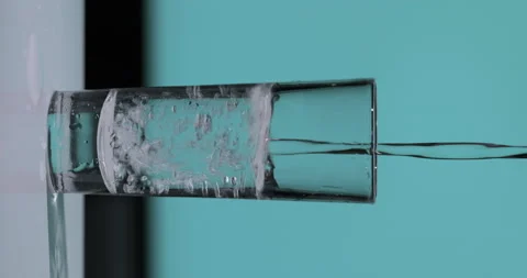 Vertical video. Bartender pouring up vodka/tequila into shots glasses Stock Footage 143127776