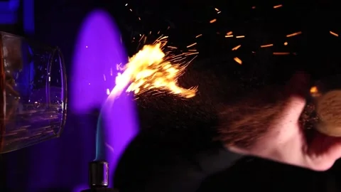 Vertical video the bartender pours cinnamon into the drink and sets it on fire Stock Footage 176391071