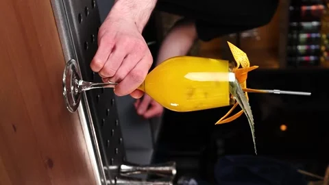 Vertical video the bartender serves a yellow cocktail slow motion bar Stock Footage 176390550