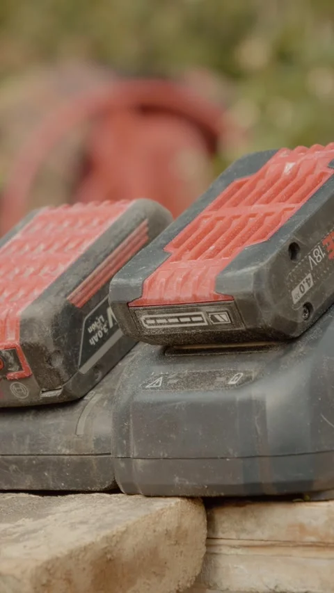 Vertical video Batteries charging for construction tools at job site in morning Stock Footage 327601164