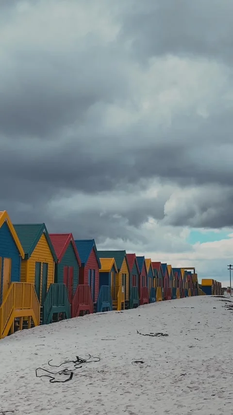 Vertical video of beach huts in a row at sandy beach Stock Footage 315786389