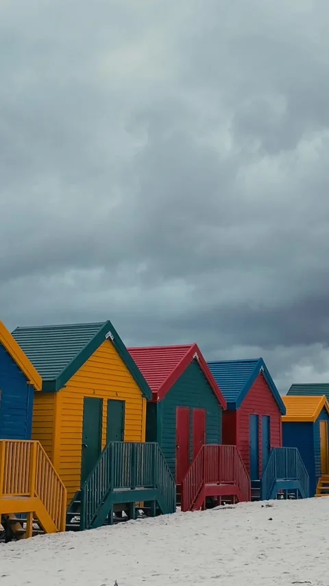 Vertical video of beach huts in a row at sandy beach Stock Footage 315786393