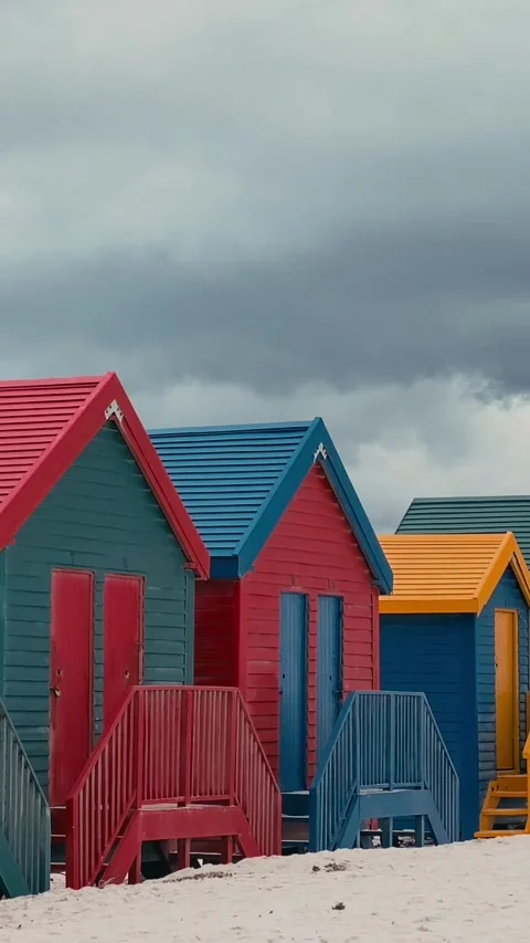 Vertical video of beach huts in a row at sandy beach Stock Footage 315786398