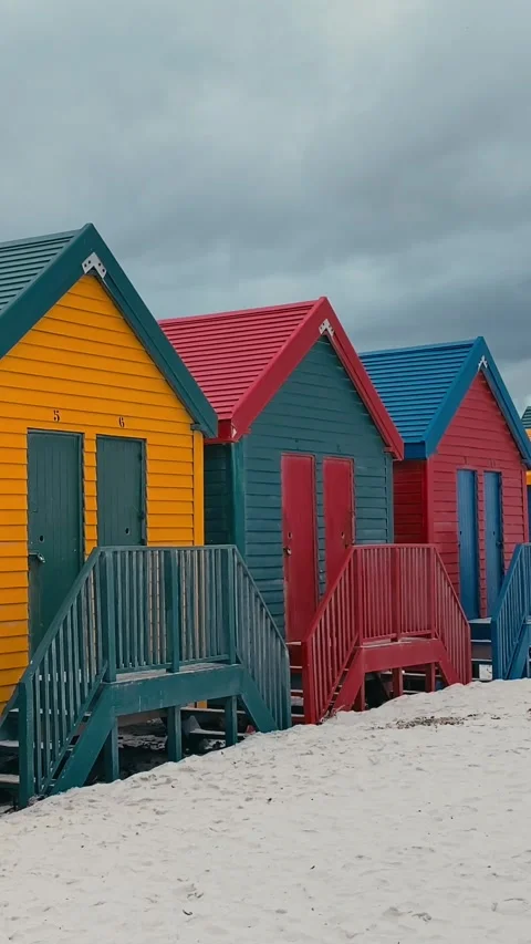 Vertical video of beach huts in a row at sandy beach Stock Footage 315786405