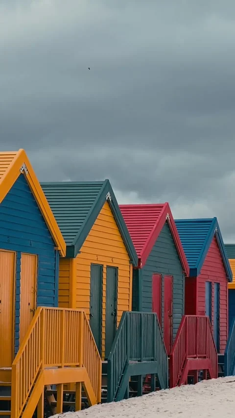 Vertical video of beach huts in a row at sandy beach 스톡 동영상 315786421