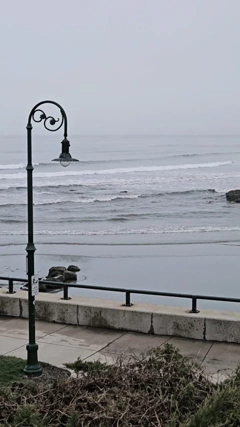 Vertical video. Beach view with waves and pole light background Stock Footage 274093432