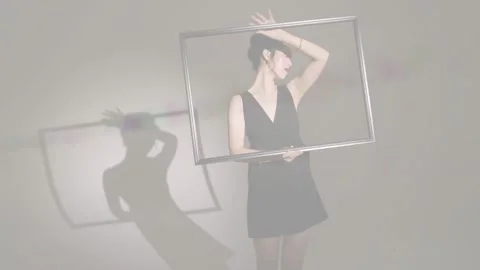 Vertical video: Beam hitting wall woman turning frame framing face shadow Stock Footage 334120537