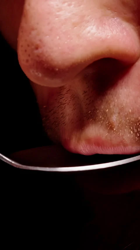 Vertical video. Bearded Man Tastes Brown Liquid From a Metal Spoon in Extreme Cl Stock Footage 341982247