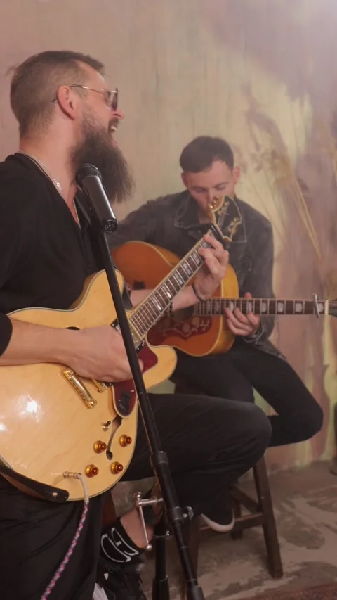 Vertical video. Bearded singer and guitarist performing live music Video stock 334776929